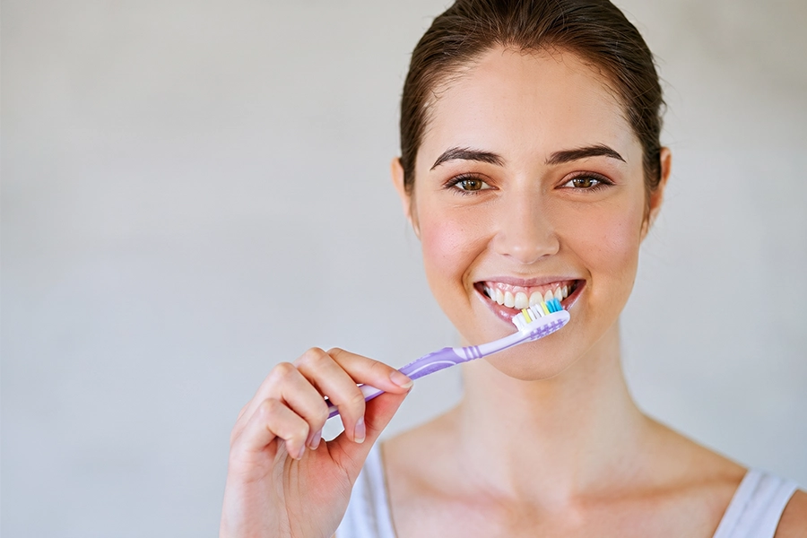 Brushing twice a day with fluoride toothpaste removes daily plaque and stains.